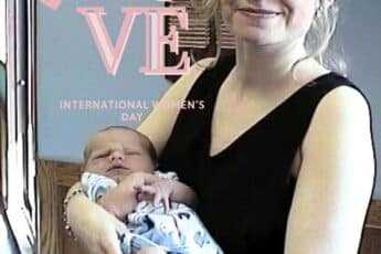 "mother holding newborn baby representing love and nurturing home energy in feng shui"